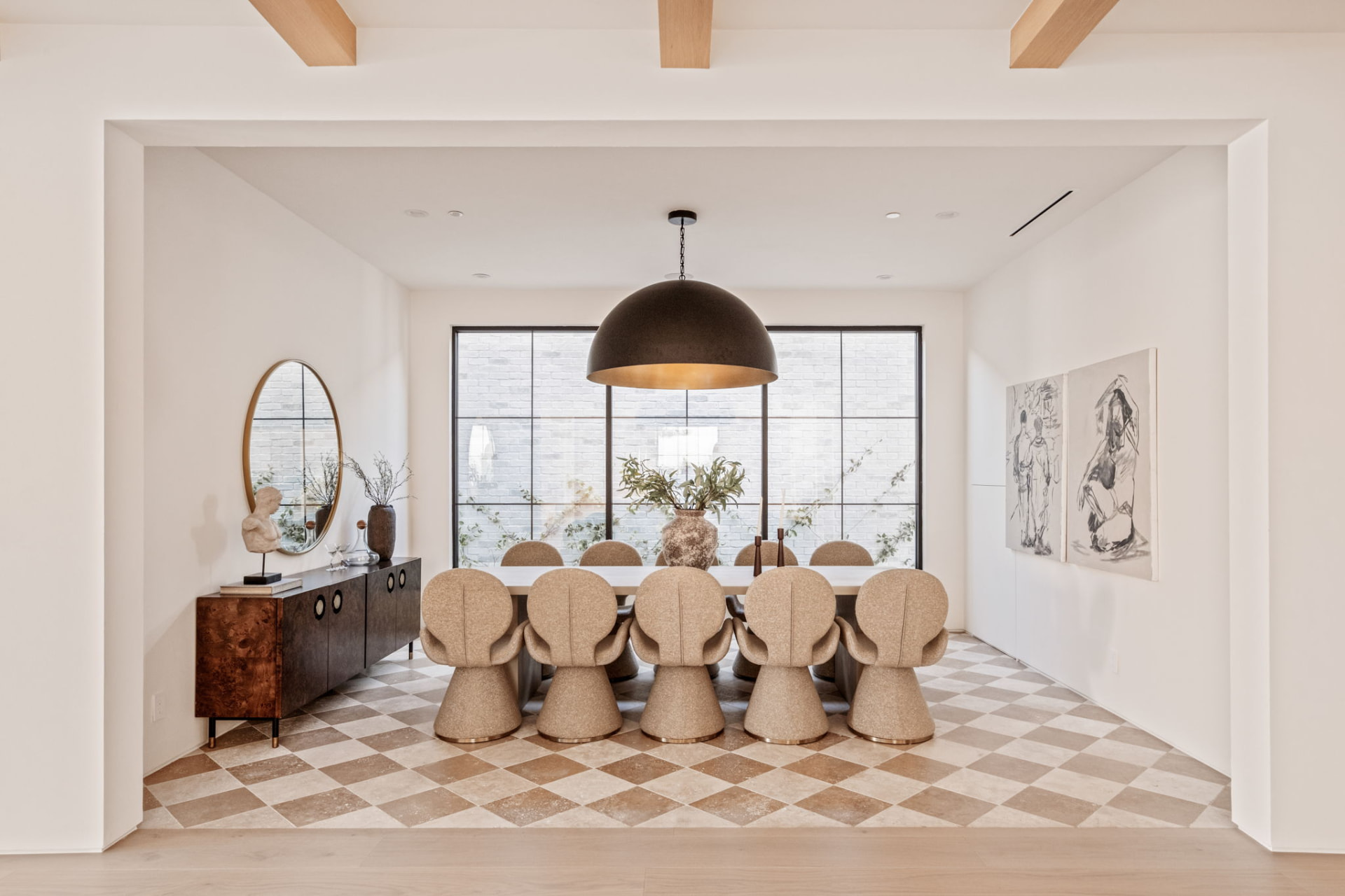 Dining room with checkered travertine floor, oversized dome pendant and steel window wall