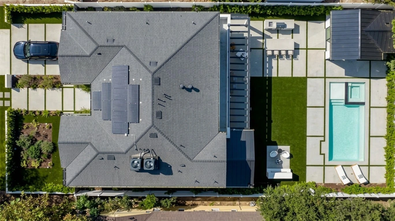 Overhead view of the residence with rooftop solar panels, landscaped garden, pool, spa and detached pavilion