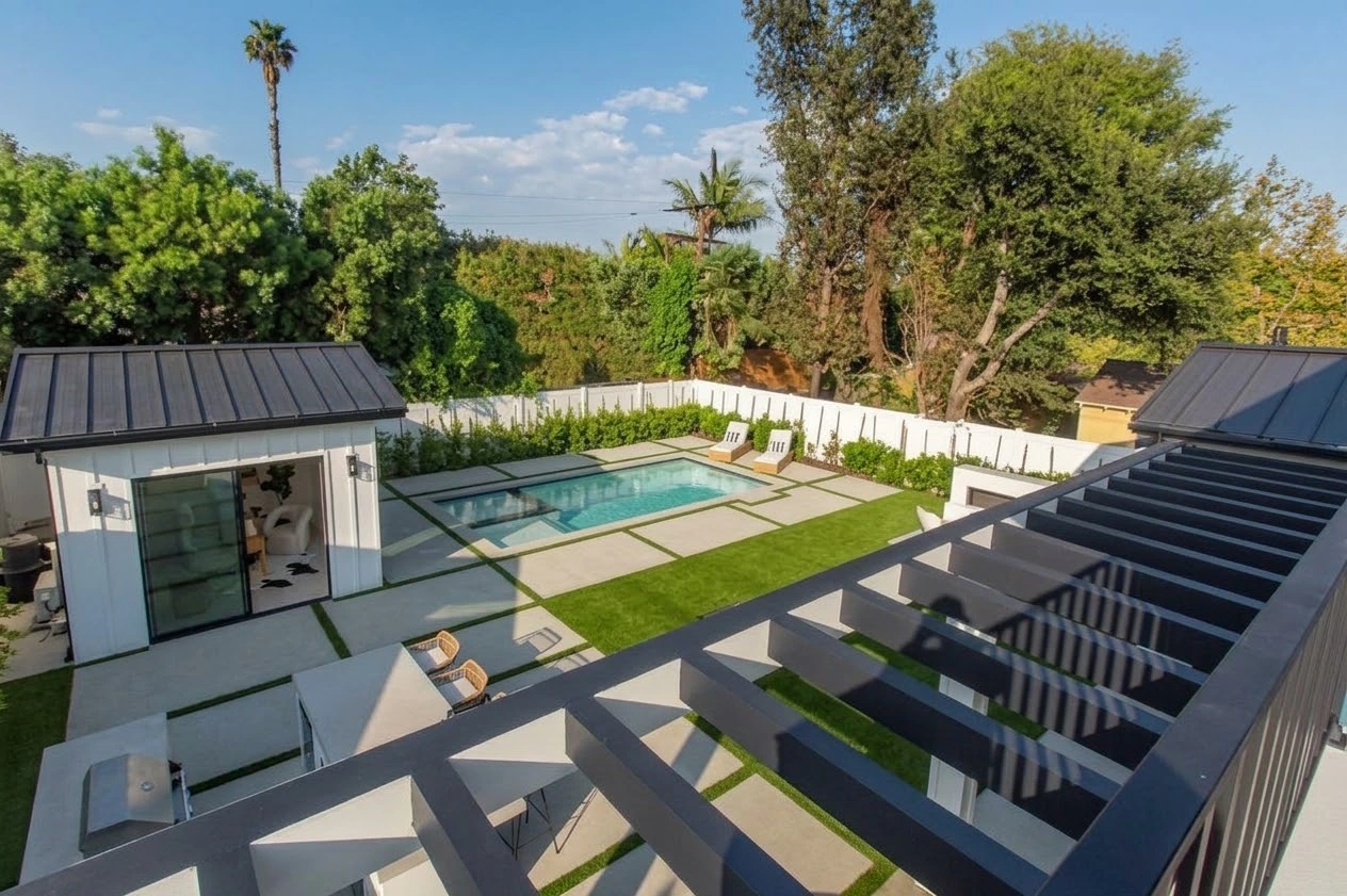 Balcony view over the pergola, lawn, pool, spa and detached garden pavilion