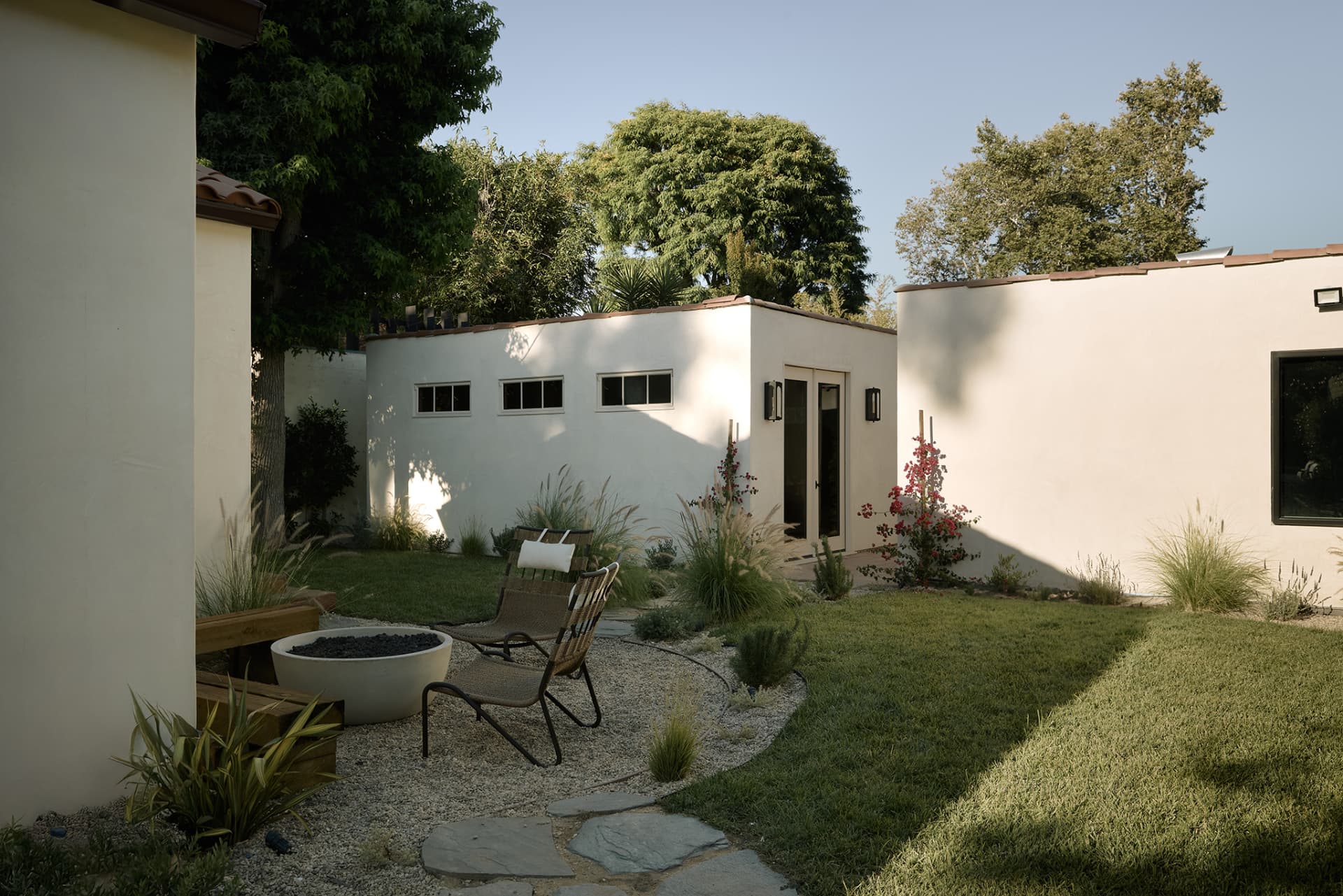 Rear garden with a fire pit, decomposed granite terrace, lawn and detached ADU